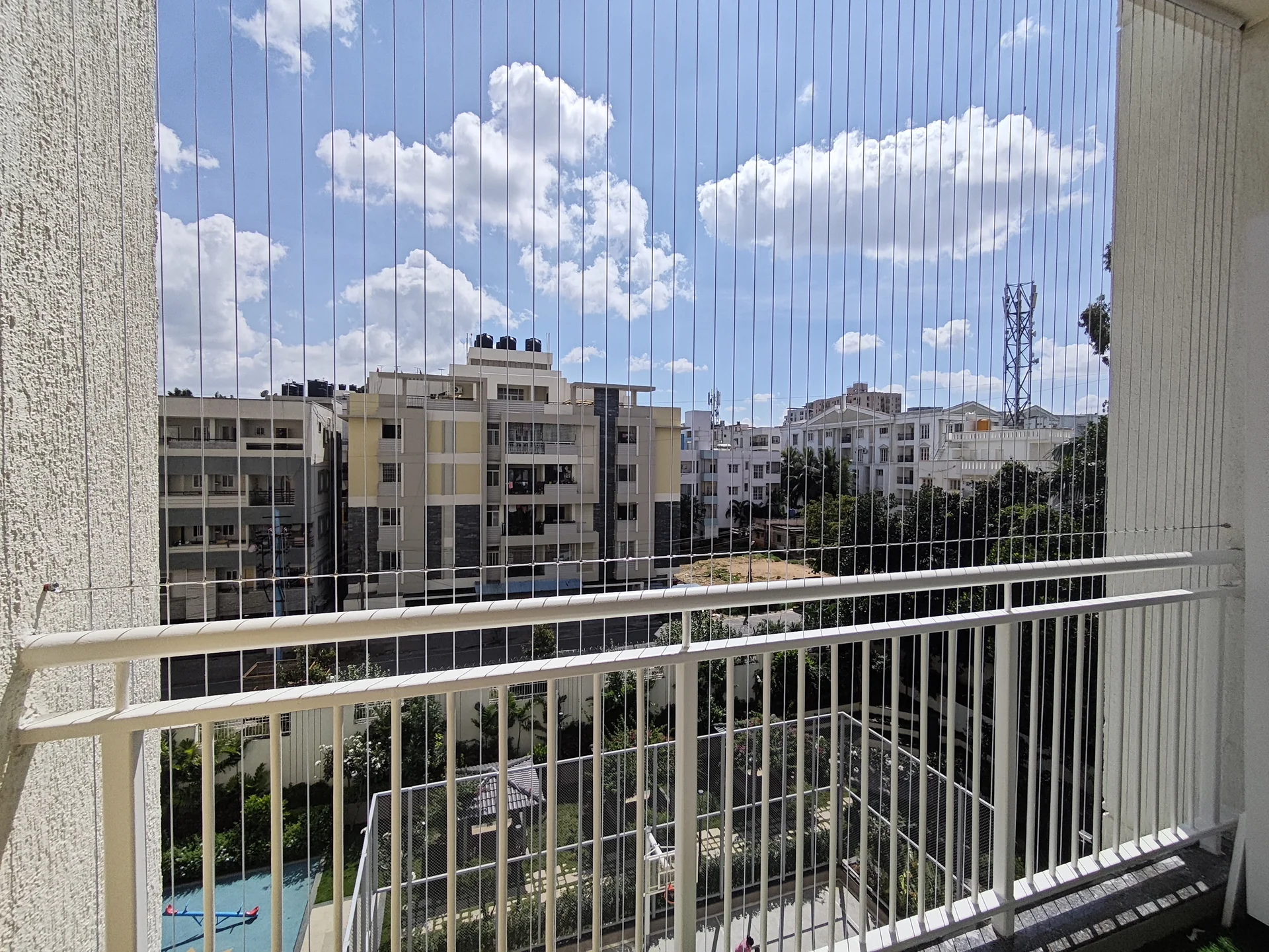 Stainless steel invisible grills fitted to a high-rise balcony — Marker Enterprises home safety installations in Chennai